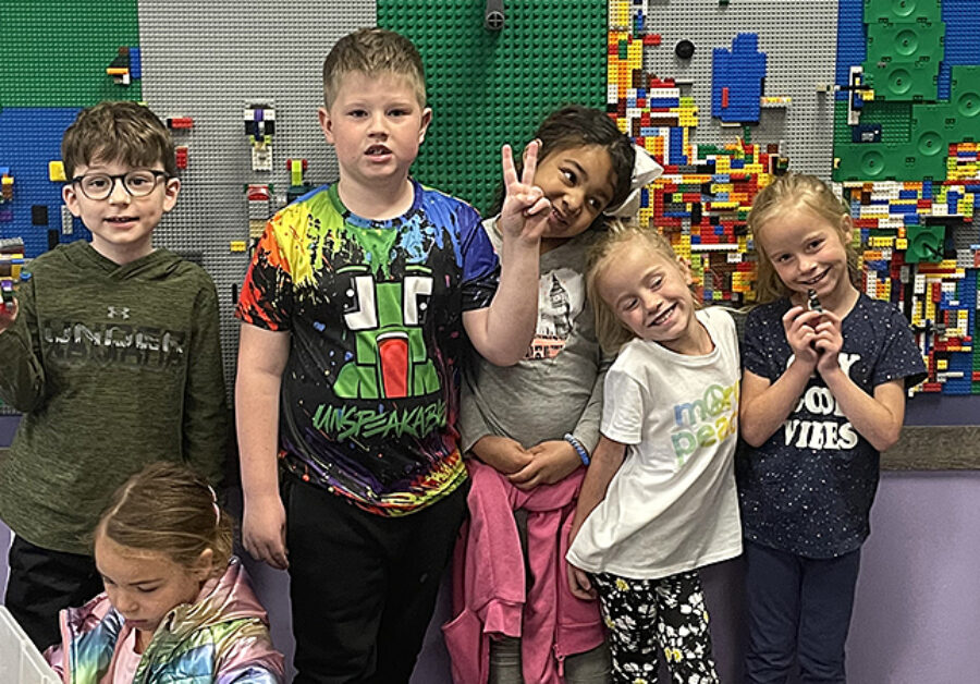 FRCS kindergarten students show off their engineering and building skills in front of the ECE Lego wall