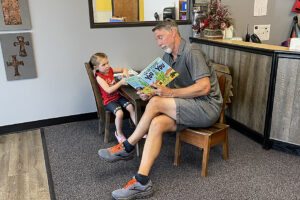 Mr. Ron reading a book to ECE student