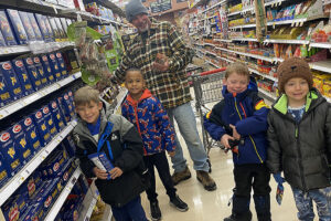 FRCS kindergarten students shop with Mr. Ron for Food Drive goods